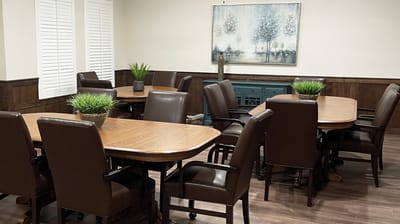 Common area with tables and chairs arranged for activities