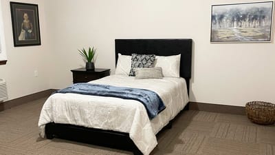Well-furnished private resident room with a bed and decor