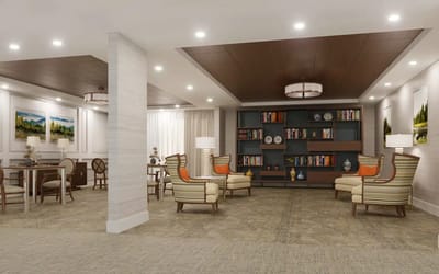 Bright common area with comfortable seating and bookshelves