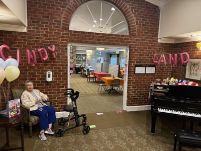 Resident in a decorated common area for a Candy Land theme event