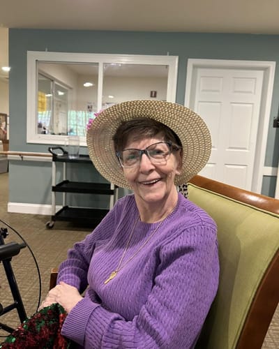 A smiling resident in a cozy common area