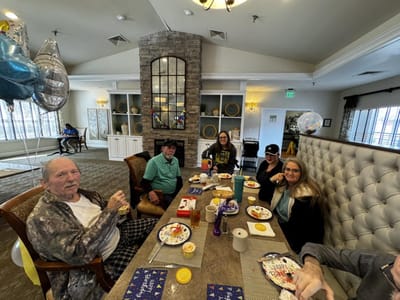 Residents enjoying a meal and celebrating in a common area