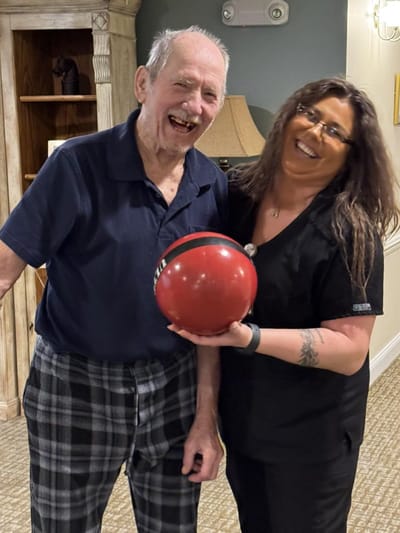 Resident and staff member sharing a joyful moment