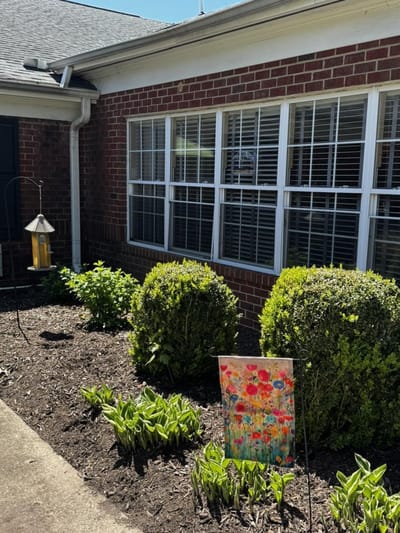 Garden area with flowers and bushes outside a facility