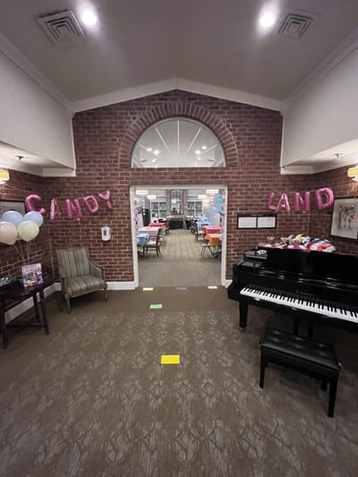 A decorated common area with a piano and colorful decorations