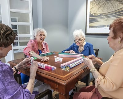 Residents enjoying a game together in an activity room