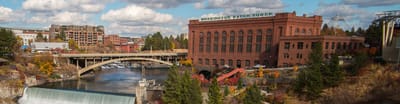 Historic building near a river with a bridge