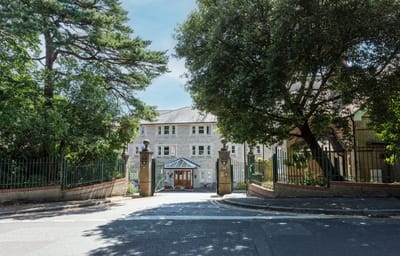 Exterior view of Brompton Court entrance surrounded by trees