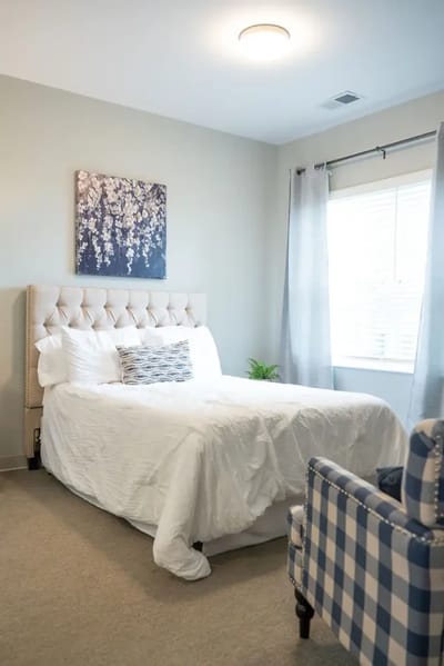 A cozy resident room with a bed and decorative accents