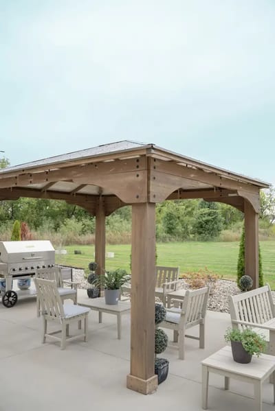 Outdoor seating area with grill and landscaping