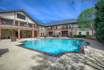 Outdoor pool area with building in the background