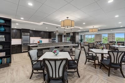 Bright dining area with tables and kitchenette