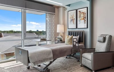 Brightly lit private room with a hospital bed and window view