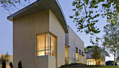 Exterior view of a modern assisted living building at dusk