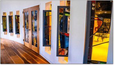 Interior view with colorful stained glass windows.