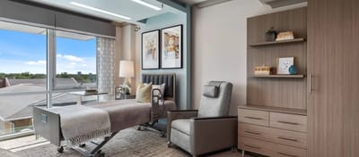 Well-furnished resident room with large window and modern decor