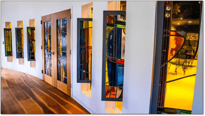 Colorful stained glass windows in a corridor