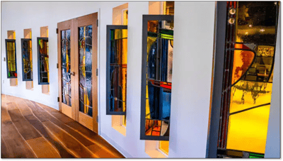 Colorful stained glass windows in a corridor