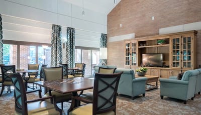 Bright common area with comfortable seating and a TV