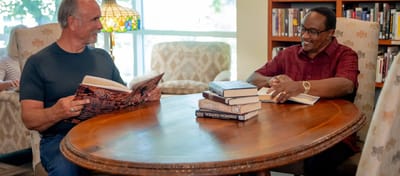 Two residents reading in a cozy common area