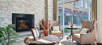 Bright common area with comfortable seating and a fireplace