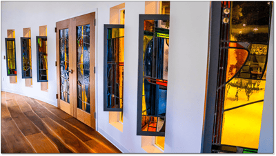 Colorful stained glass windows in a hallway
