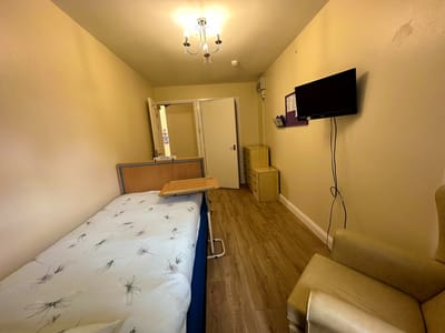 Cozy resident room with a bed and chair