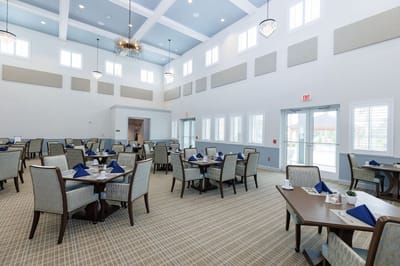 Interior view of a dining room with tables set