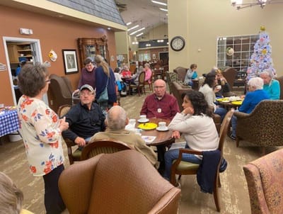Residents socializing in a common area with snacks