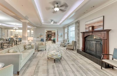 Common area with seating and fireplace in a senior living facility