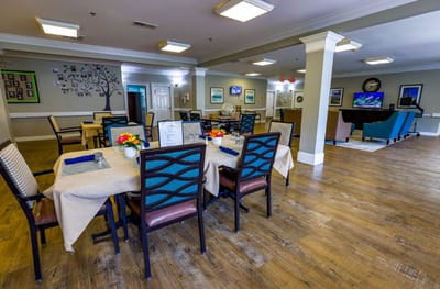 Dining area with tables and chairs set up for residents