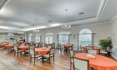 Bright dining room layout with orange tablecloths