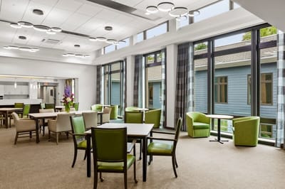 Bright common area with large windows and modern furniture