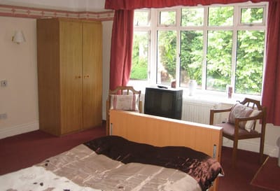 Cozy resident room with a bed and window view