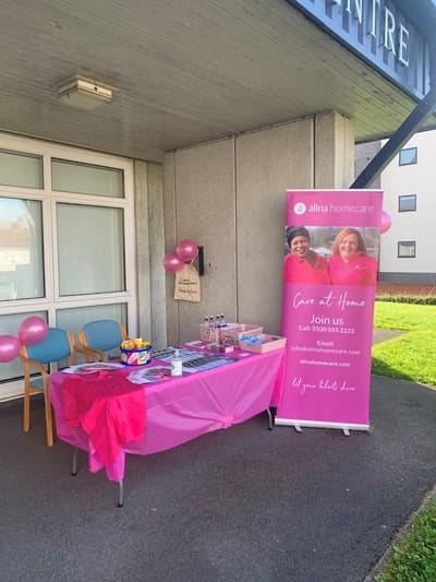 Outdoor event table with promotional materials and balloons