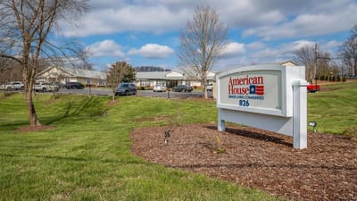 Signage for American House Bristol near well-kept lawns
