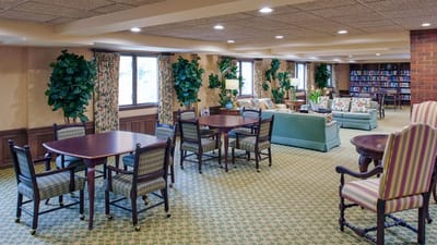 Bright common area with comfortable seating and tables