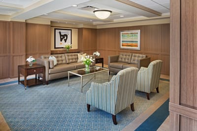Cozy lounge area with seating and artwork