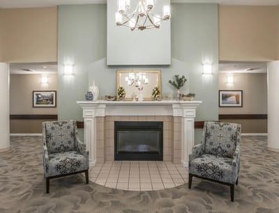 Comfortable common area with chairs and a fireplace