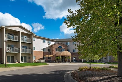 Exterior view of a senior living facility with outdoor space
