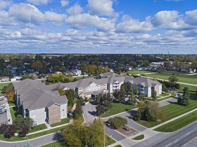 Aerial view of an assisted living campus with green spaces