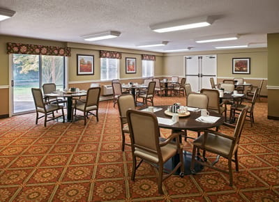 Dining room with tables and chairs in a bright setting
