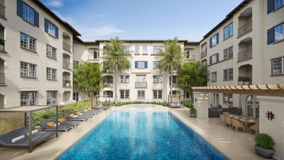 A serene outdoor pool area surrounded by buildings