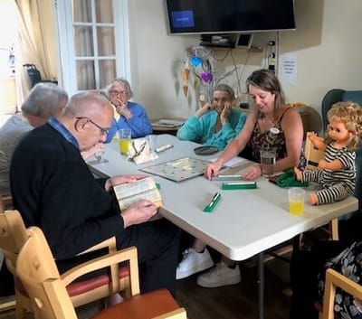 Residents enjoying a game activity around a table