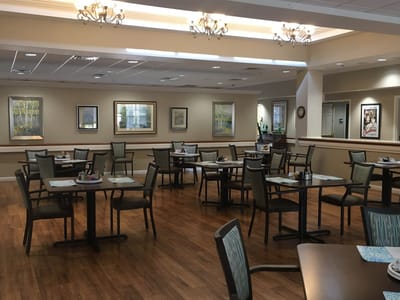 Dining area with tables and artwork on the walls