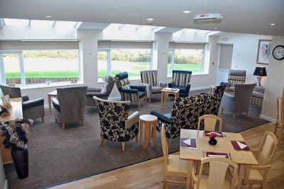Bright common area with comfortable seating and large windows