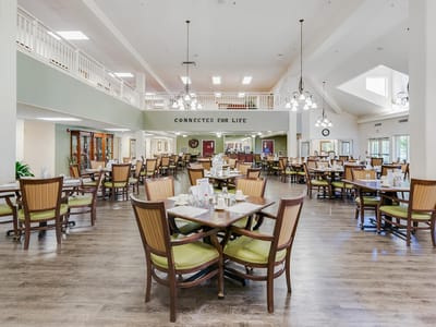 Bright dining area with tables and chairs arranged