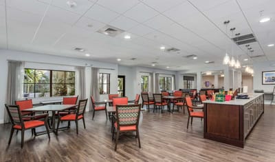 Interior view of a common area with dining tables and chairs