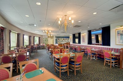 Dining room with tables and chairs set for meals