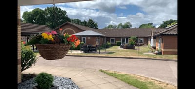 Outdoor view of Avocet Court Care Home with flowers